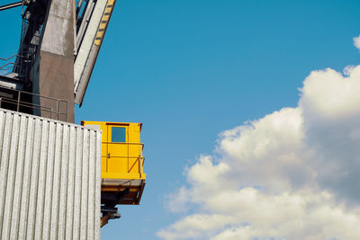 Low angle view of yellow building against sky