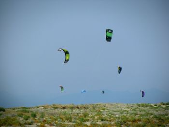 Low angle view of kite flying against clear blue sky