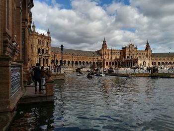 View of buildings against cloudy sky