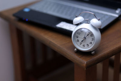 Close-up of clock on table