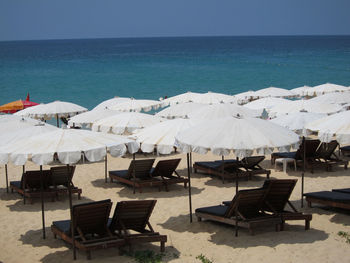 Sunshades and lounge chairs on shore