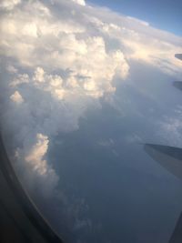 Aerial view of cloudscape seen from airplane window