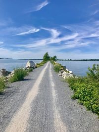 Road by sea against sky