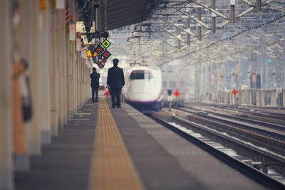 People waiting at railroad station