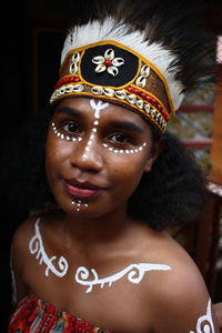 Portrait of native papua woman with traditional face painting