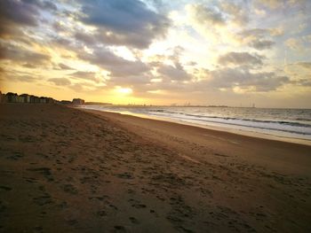 Scenic view of beach against sky during sunset