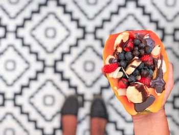 Midsection of person holding fruits