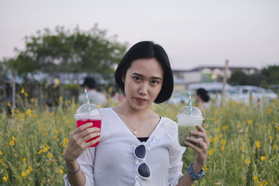 Portrait of young woman drinking glass