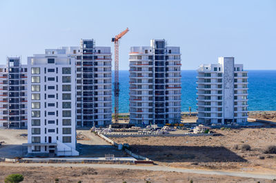 Buildings in city against clear sky