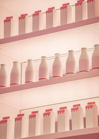 A backgroundof white and pink cartons on a shelf.