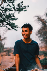 Young man smiling while standing outdoors