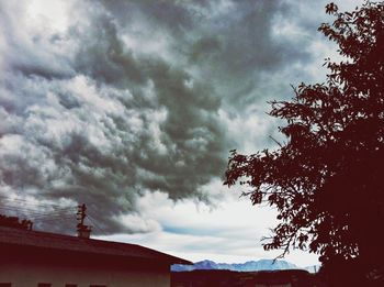 Low angle view of building against cloudy sky