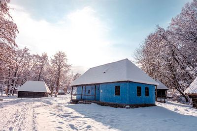 Traditional romanian village in transylvania with old house straw roofing covered with snow 