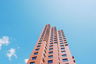 Low angle view of modern building against blue sky