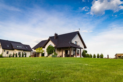 House on field against sky
