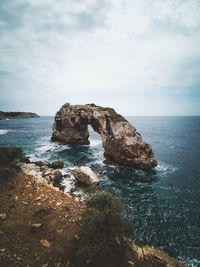 Rock formation on sea shore against sky mallorca 