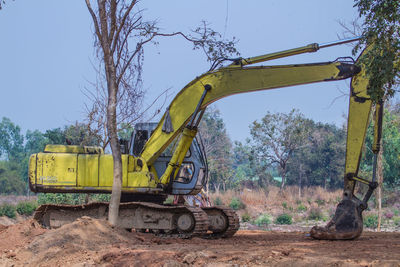 Bulldozer breaking trees at construction site