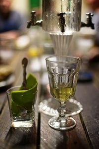 Close-up of wine glasses on table