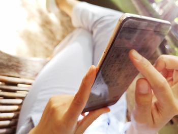 Midsection of man using mobile phone