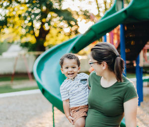 Mother and diverse mixed race toddler so. at park having fun bonding together