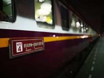 Close-up of train at illuminated railroad station