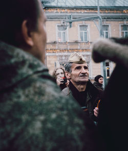 Portrait of young man standing in city