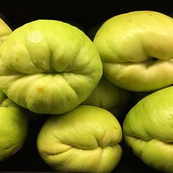 Close-up of organic chayote squash vegetables against black background