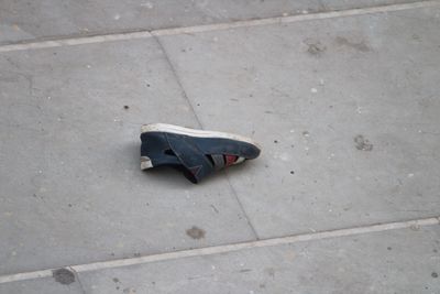 High angle view of shoes on sidewalk