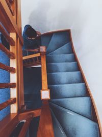 High angle view of young man moving up on steps