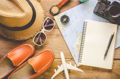 High angle view of diary and travel accessory on table