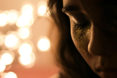 Cropped image of young woman with glitter on her face