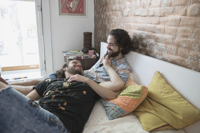 Young couple sitting on sofa at home