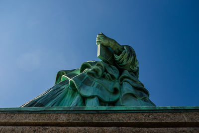 Low angle view of statue against clear blue sky