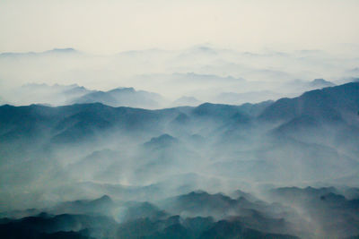 Scenic view of mountains against cloudy sky
