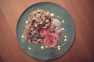 High angle view of pink flowers in bowl on table