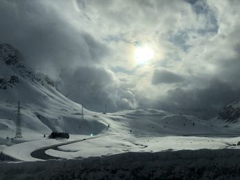 Scenic view of snow covered mountains against sky