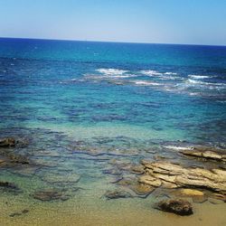 Scenic view of sea against clear blue sky