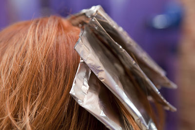 Close-up of woman highlighting hair at salon