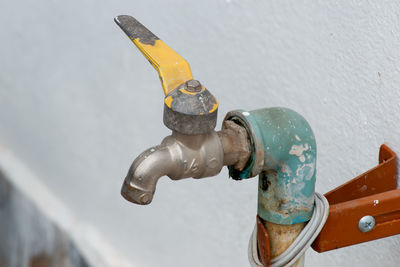 High angle view of faucet on wet wall