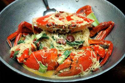 High angle view of crab with noodles served in wok