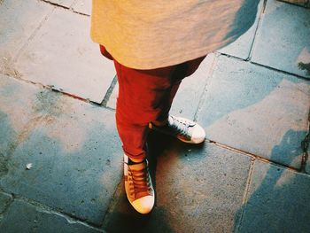 Low section of man standing on footpath