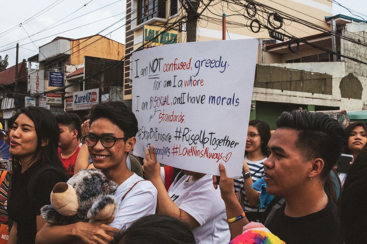 group of people, real people, city, women, architecture, communication, men, text, large group of people, protest, adult, street, lifestyles, crowd, day, togetherness, banner - sign, building exterior, young adult, protestor