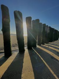 Sunlight falling on rocks against clear sky