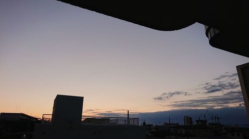 Low angle view of silhouette buildings against sky during sunset