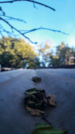 Surface level of cobblestone street against clear blue sky