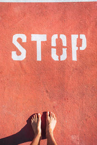 Low section of man standing by text