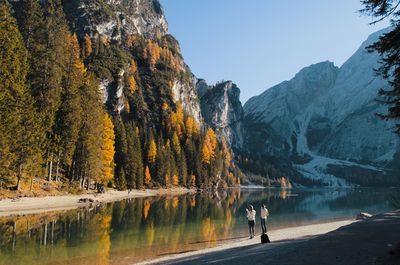 Scenic view of lake by mountain against clear sky