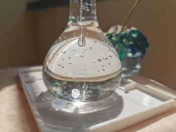 Close-up of water in glass on table at home