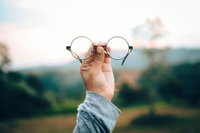 Close-up of hand holding eyeglasses