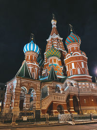 Low angle view of illuminated building against sky at night